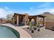 Picturesque poolside patio with a covered bar and outdoor kitchen area perfect for entertaining and dining at 9607 E Mckellips Rd, Mesa, AZ 85207