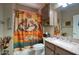 Comfortable bathroom with a granite counter, and shower with desert-themed curtain at 9750 N Monterey Dr # 71, Fountain Hills, AZ 85268