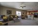 Inviting living room featuring plush seating, a ceiling fan, and seamless flow to the open-concept kitchen at 9750 N Monterey Dr # 71, Fountain Hills, AZ 85268