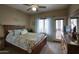 Serene main bedroom with a comfortable bed, natural light, and access to an outdoor balcony at 9750 N Monterey Dr # 71, Fountain Hills, AZ 85268