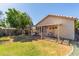 Spacious backyard featuring a covered patio, lush greenery, and manicured landscaping at 10465 W Windsor Blvd, Glendale, AZ 85307