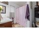 Comfortable bathroom featuring a warm vanity and a decorative shower curtain at 10465 W Windsor Blvd, Glendale, AZ 85307