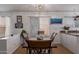 Cozy dining area with rustic wood table and a decorative light fixture under a bright window at 10465 W Windsor Blvd, Glendale, AZ 85307
