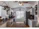 Well-lit kitchen featuring modern appliances, granite counters, white cabinets, and a hanging pot rack at 10465 W Windsor Blvd, Glendale, AZ 85307