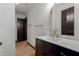 Bathroom with a modern sink, gold faucet, and black cabinets at 10849 E Elmwood St St, Mesa, AZ 85207
