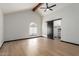 Primary bedroom features wood beam, fan, modern barn door to closet and light wood flooring at 10849 E Elmwood St St, Mesa, AZ 85207