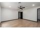 A serene bedroom featuring modern ceiling fan, wood floors and neutral walls at 10849 E Elmwood St St, Mesa, AZ 85207