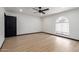 Bedroom features a modern fan, black door and wood flooring at 10849 E Elmwood St St, Mesa, AZ 85207