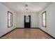 Tile-floor dining room featuring chandelier, black door, and shuttered windows at 10849 E Elmwood St St, Mesa, AZ 85207