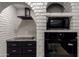 Bright white brick arch around modern built in appliances and decorative backsplash at 10849 E Elmwood St St, Mesa, AZ 85207