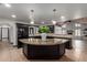 Kitchen island featuring granite countertop, with black cabinetry, sink, and appliances at 10849 E Elmwood St St, Mesa, AZ 85207