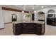 Kitchen island with granite countertops and white pendant lighting, and black cabinets at 10849 E Elmwood St St, Mesa, AZ 85207