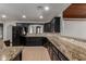 Bright kitchen with black cabinetry, granite countertops, and stainless steel appliances at 10849 E Elmwood St St, Mesa, AZ 85207
