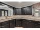 Kitchen with black cabinets, granite countertops, and stainless steel appliances at 10849 E Elmwood St St, Mesa, AZ 85207