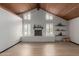 Well-lit living room with wood floors, fireplace with brick surround, and wood beamed ceiling at 10849 E Elmwood St St, Mesa, AZ 85207