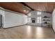 Bright living room with brick fireplace, wood ceiling, and wood laminate flooring at 10849 E Elmwood St St, Mesa, AZ 85207