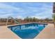 A refreshing backyard pool with a slide surrounded by desert landscaping at 10849 E Elmwood St St, Mesa, AZ 85207