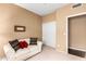 Cozy bedroom featuring a comfortable sofa, neutral carpet, and closet at 11807 E Clinton St, Scottsdale, AZ 85259
