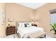 Bedroom with neutral tones, plush bedding, bedside tables, and bright natural light at 11807 E Clinton St, Scottsdale, AZ 85259