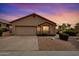 Charming single-story home featuring desert landscaping, a two-car garage, and neutral tones at 11807 E Clinton St, Scottsdale, AZ 85259