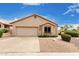 Charming single-story home featuring desert landscaping, a two-car garage, and a neutral color palette at 11807 E Clinton St, Scottsdale, AZ 85259