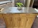 Close up of stainless-steel kitchen island with wood cabinets, drawers, and a built-in paper towel rack at 11807 E Clinton St, Scottsdale, AZ 85259