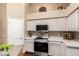 Kitchen features modern appliances, built in microwave, and storage. The island features stainless countertops at 11807 E Clinton St, Scottsdale, AZ 85259