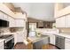 Bright, open kitchen featuring stainless appliances, custom island, and seamless flow to the outdoor space at 11807 E Clinton St, Scottsdale, AZ 85259
