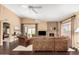 Spacious living room with high ceilings, ceiling fans, stone fireplace, and leather furnishings at 11807 E Clinton St, Scottsdale, AZ 85259