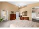 A large main bedroom featuring a vaulted ceiling, backyard access, and en-suite bathroom at 11807 E Clinton St, Scottsdale, AZ 85259
