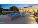 Beautiful pool and spa with water features are surrounded by a stone patio and lush manicured landscape at 12240 N 98Th St, Scottsdale, AZ 85260