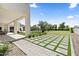 Lush backyard with manicured lawn, paved areas, and mature trees for a serene outdoor setting at 12240 N 98Th St, Scottsdale, AZ 85260