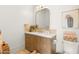 Elegant bathroom with a wooden vanity, decorative mirror, and modern fixtures for a spa-like experience at 12240 N 98Th St, Scottsdale, AZ 85260