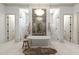 Elegant bathroom featuring a freestanding tub, dual walk-in showers with marble, and modern chandelier at 12240 N 98Th St, Scottsdale, AZ 85260
