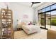 Bright bedroom featuring a large window, unique decor, and ample natural light for a cheerful ambiance at 12240 N 98Th St, Scottsdale, AZ 85260