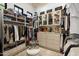 Custom closet featuring ample shelving, drawers, and hanging space for clothes and accessories at 12240 N 98Th St, Scottsdale, AZ 85260