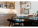 Dining room with modern table, custom display cabinet, and an array of curated wall art at 12240 N 98Th St, Scottsdale, AZ 85260