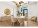 Elegant dining room with modern chandelier, hardwood floors, and backyard view at 12240 N 98Th St, Scottsdale, AZ 85260