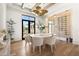 Modern dining room with a round table, stylish chairs, unique lighting, and a wine display at 12240 N 98Th St, Scottsdale, AZ 85260
