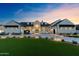 Stunning exterior elevation of a home with a well-manicured lawn and elegant facade at twilight at 12240 N 98Th St, Scottsdale, AZ 85260
