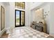 Stunning foyer featuring checkered tile floors, a large mirror, and an elegant console table at 12240 N 98Th St, Scottsdale, AZ 85260
