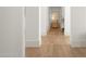 Hallway featuring hardwood flooring, white pillars, and natural light at 12240 N 98Th St, Scottsdale, AZ 85260