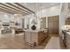 Spacious open-concept kitchen and living room with wood beams, marble countertops, and stainless appliances at 12240 N 98Th St, Scottsdale, AZ 85260