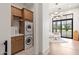 Functional laundry room featuring stacked washer and dryer, ample storage, and backyard view at 12240 N 98Th St, Scottsdale, AZ 85260