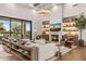 Elegant living room with fireplace, custom shelving, and ample natural light at 12240 N 98Th St, Scottsdale, AZ 85260
