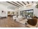 Open-concept living room with hardwood floors, exposed beams, and seamless indoor-outdoor flow at 12240 N 98Th St, Scottsdale, AZ 85260