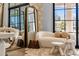 Bright living room featuring a plush white sofa, decorative mirror, and stylish accents at 12240 N 98Th St, Scottsdale, AZ 85260