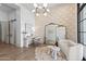 Bright living room featuring a plush white sofa, decorative mirror, and stylish accents at 12240 N 98Th St, Scottsdale, AZ 85260