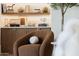 Cozy living room featuring elegant shelving with decorative items and comfortable seating area at 12240 N 98Th St, Scottsdale, AZ 85260