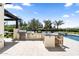 Custom outdoor kitchen features stainless steel appliances and a beautiful stone countertop, adjacent to the pool at 12240 N 98Th St, Scottsdale, AZ 85260